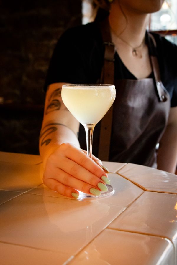 A bartender pouring at the bar